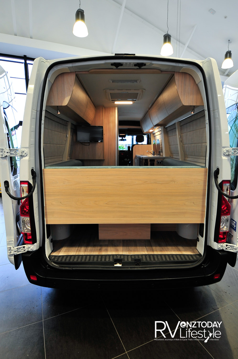 The back doors open right up and secure to the sides. Storage under the back seating